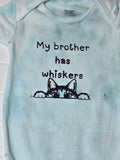 Light blue baby onesie with text and cat illustration, 