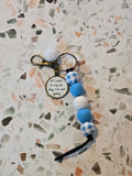 Keychain with beads on a textured surface