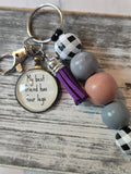 Keychain with beads and a tag on a wooden surface