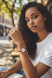 Woman wearing a watch with a blurred outdoor background