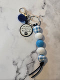 Beaded keychain with a tag on a marble surface