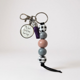 Keychain with beads and a tag on a white background