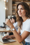 Woman using a laptop in a casual setting with a blurred background