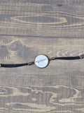 bracelet with a chain on a wooden surface