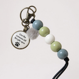 Keychain with beads and a motivational quote on a light background